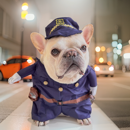 Dog in a police uniform standing on a city street at night.